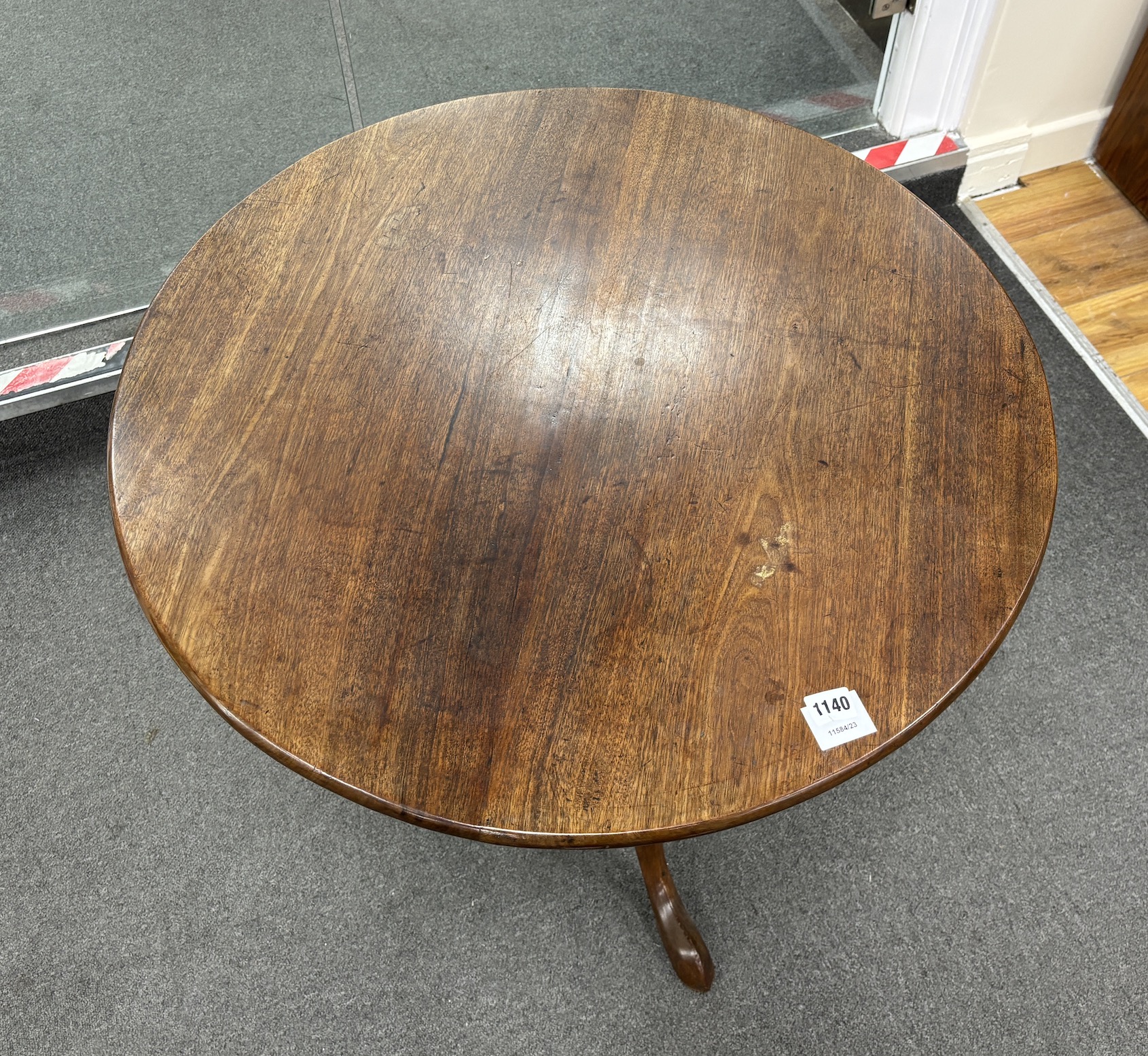 A George III circular mahogany tilt top tripod tea table, width 76cm, height 72cm